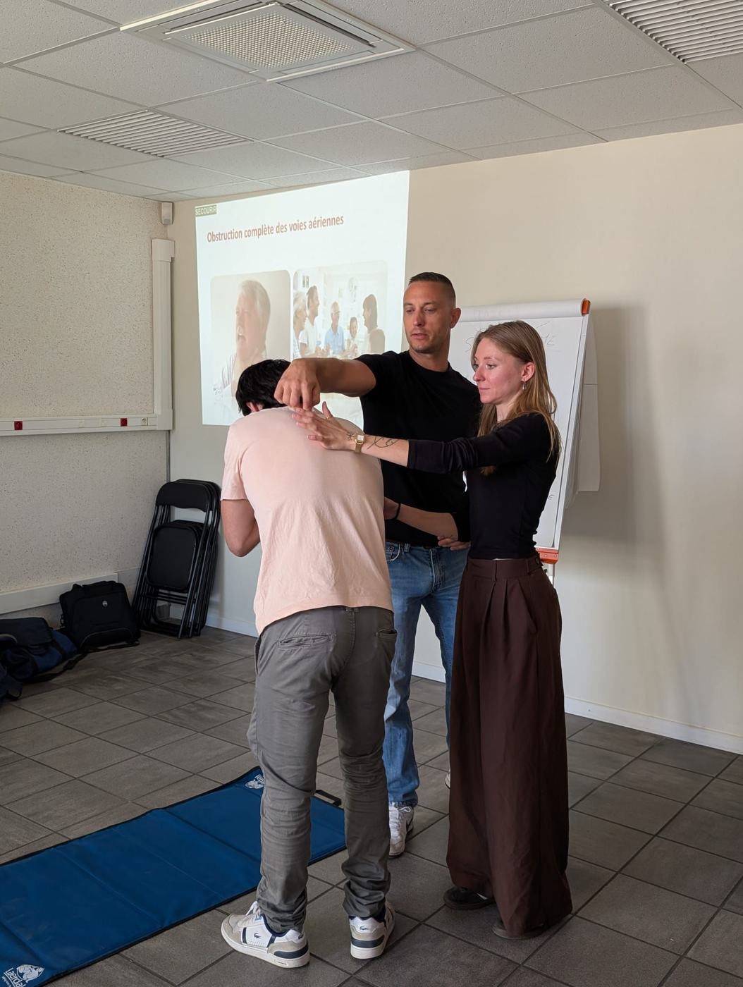 Geste de secours face à une victime qui s'étouffe, formation SST en salle